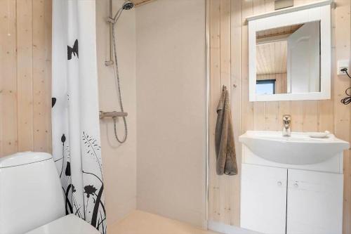 a bathroom with a white sink and a shower at 40607-Juelsminde-Pilevaenget-16 in Juelsminde
