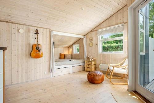 a room with a guitar in the corner of a room at 30415-Odder-Strandparksvej-50 in Odder
