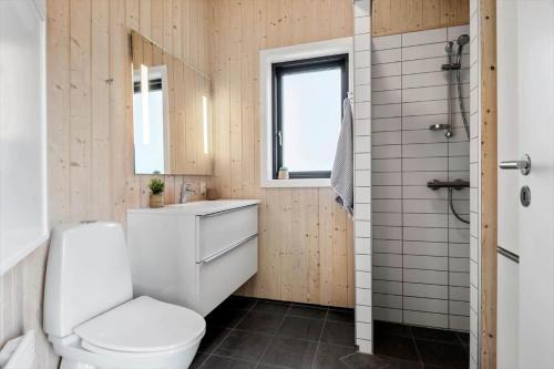 a bathroom with a toilet and a sink and a shower at 30427-Saksild-Strandvaenget-31 in Saksild