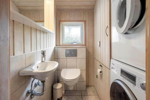 a small bathroom with a toilet and a sink at M369-Vaeggerlose-Mimosevej-19 in Bøtø By