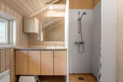 a small bathroom with a sink and a shower at M397-Vaeggerlose-Stolt-Henriksvej-111 in Bøtø By