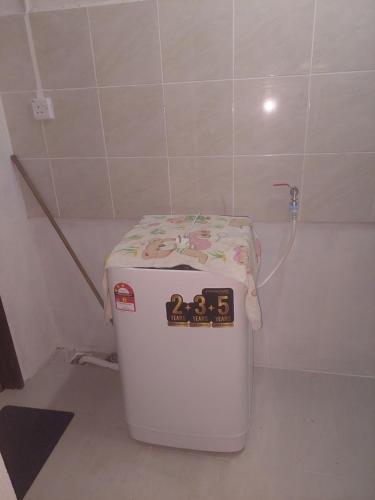 a small refrigerator with a towel on top of it at Sumud Bonda Homestay in Kuala Kerai