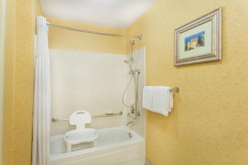 a bathroom with a toilet and a bath tub at Baymont by Wyndham Flagstaff in Flagstaff