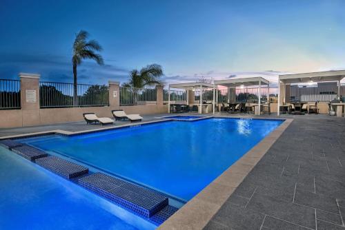 a swimming pool with blue water in a resort at Hawthorn Extended Stay by Wyndham McAllen in McAllen