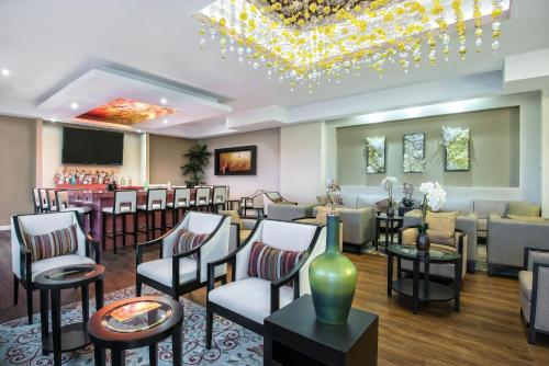 a hotel lobby with a bar with chairs and a waiting room at Hawthorn Extended Stay by Wyndham McAllen in McAllen