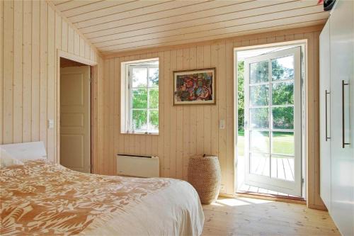 a bedroom with a bed and two windows in it at 902-N-Tisvildeleje-Klovervej-9 in Tisvildeleje