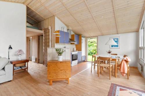 a kitchen and living room with a table and chairs at 1497-N-Gilleleje-Parcelvej-3 in Gilleleje