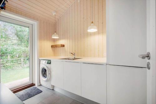 a kitchen with a refrigerator and a washing machine at 1576-Liseleje-Korntoften-7 in Liseleje