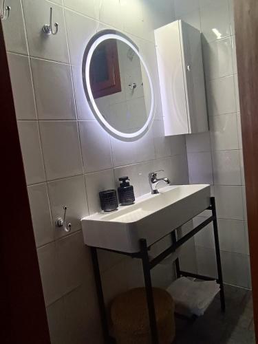 a bathroom with a sink and a mirror at Eden's Garden Kalamitsi in Kalamitsi