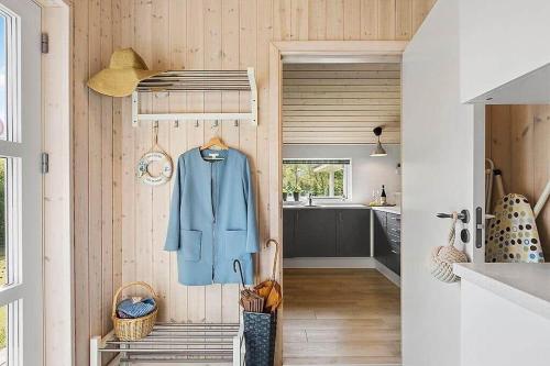 a kitchen with a blue jacket hanging on a wall at 1572-Melby-Kildegardsvej-10 in Melby