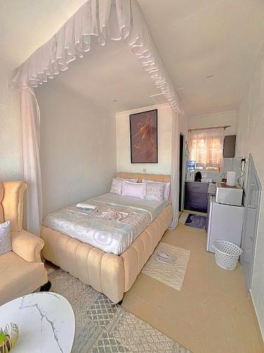 a bedroom with a large bed in a room at Luxury Homely Apt studio with pool in Kisumu
