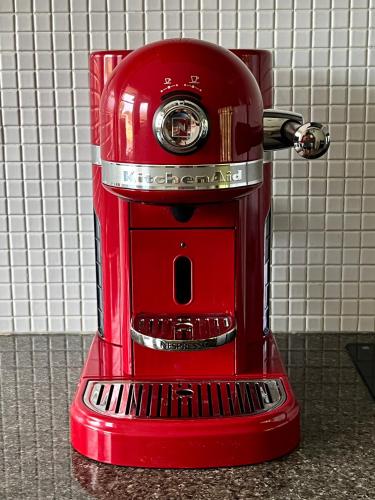 a red coffee maker sitting on a counter at Campbell comfort and convenience in Campbell