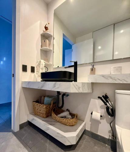 a bathroom with white cabinets and a sink at Stylish Loft for 4 Reforma CDMX Ideal Long Stay in Mexico City