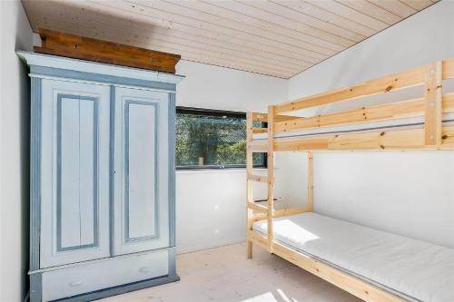 a room with a bunk bed and a ladder and a window at 1164-N-Melby-Bjergvej-7 in Melby