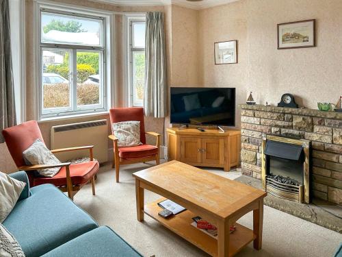 a living room with a couch and a fireplace at The Castaway in Mundesley