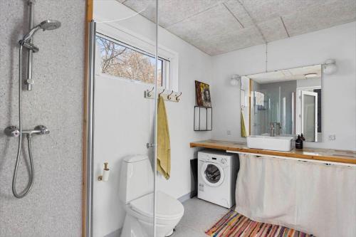 a bathroom with a shower and a toilet and a sink at 1642-Hundested-Egernvej-1 in Hundested