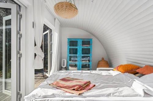 a bedroom with a bed and a blue cabinet at 1642-Hundested-Egernvej-1 in Hundested