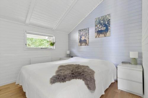 a white bedroom with a bed and a window at 1630-Frederiksvaerk-Munkebakken-2 in Frederiksværk