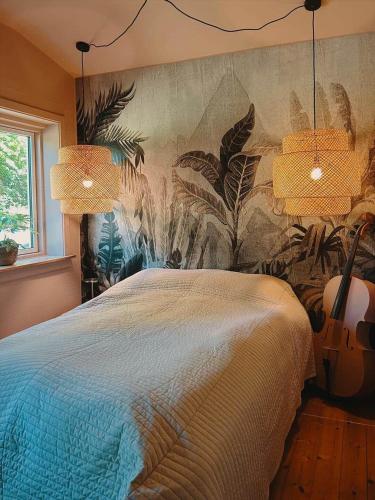 a bedroom with a bed and two lamps and a guitar at 1645-Graested-Udsholt-Strandvej-101 in Græsted