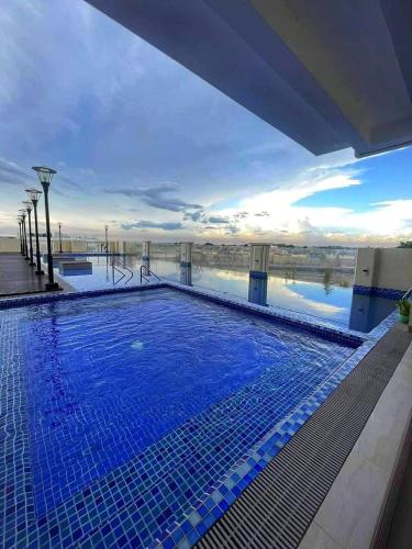 a swimming pool on top of a building with water at TuksHotel in Manila