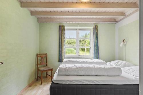 a bedroom with two beds and a window at 10820-Ulfborg-Baekbyvej-113 in Ulfborg