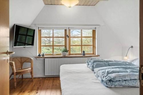 a bedroom with three beds and a window at 10439-Ulfborg-Gaffelbjergvej-60 in Ulfborg