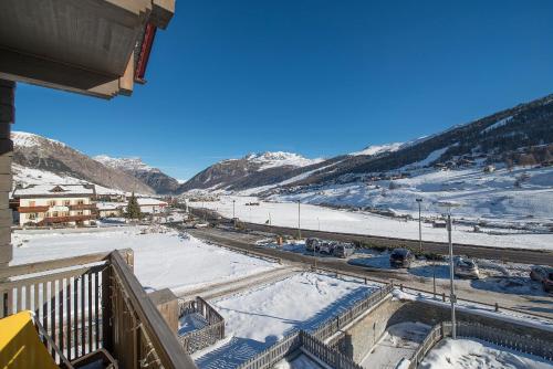 a balcony with a view of a snow covered mountain at Hotel Marzia in Livigno