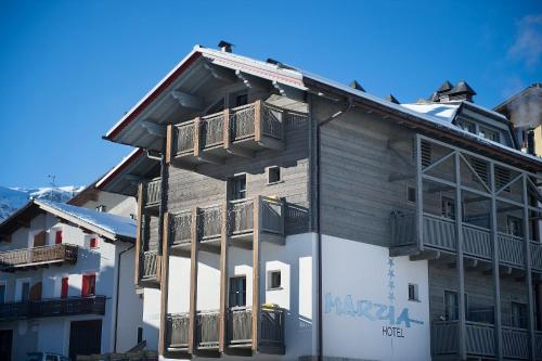 a building with a balcony on the side of it at Hotel Marzia in Livigno