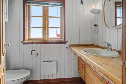 a bathroom with a sink and a toilet and a mirror at 10019-Ulfborg-Gaffelbjergvej-18 in Ulfborg