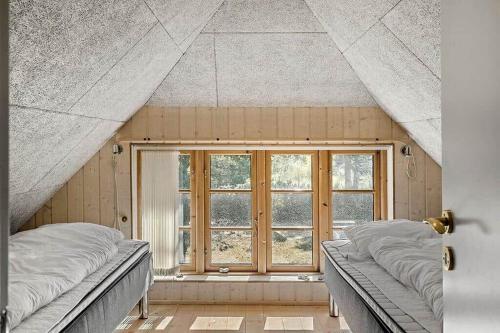 a bedroom with two beds and a window at 10019-Ulfborg-Gaffelbjergvej-18 in Ulfborg