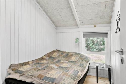 a bed in a white room with a window at 30134-Ulfborg-Klovervej-475 in Ulfborg