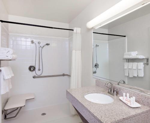 a bathroom with a sink and a shower at Days Inn by Wyndham San Angelo in San Angelo