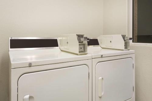 two machines sitting on top of a white refrigerator at Days Inn by Wyndham Bullhead City in Bullhead City