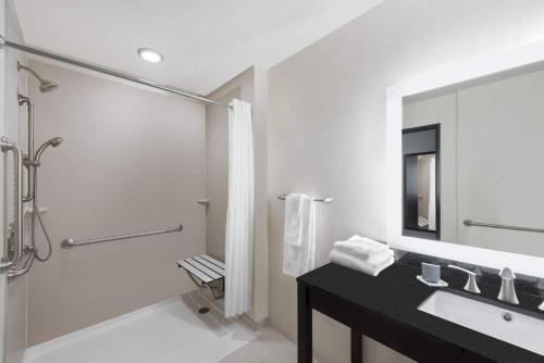 a bathroom with a sink and a shower at Wingate by Wyndham Loveland Johnstown in Loveland