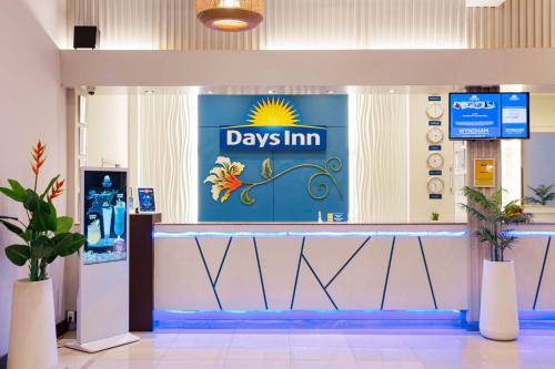 a shop with a day inn sign on the wall at Days Inn by Wyndham Patong Beach in Patong Beach