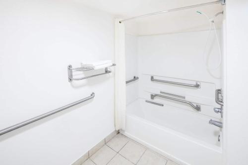 a shower in a bathroom with a glass door at Howard Johnson by Wyndham Vicksburg in Vicksburg