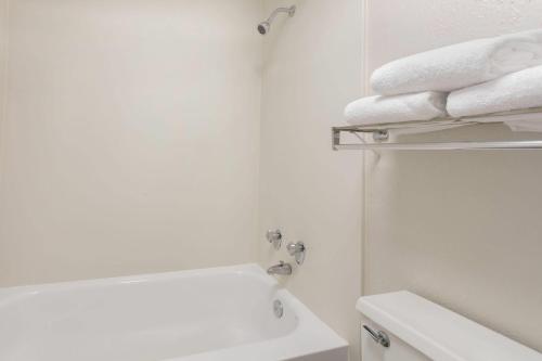 a bathroom with a sink and a toilet and towels at Baymont by Wyndham Greenville Woodruff Rd in Greenville