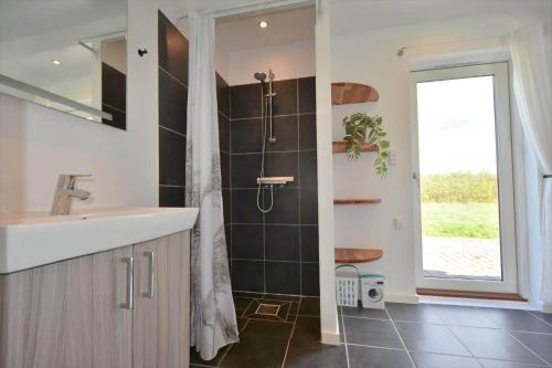 a bathroom with a sink and a shower at 20135-Ulfborg-Fyrrebakken-7 in Ulfborg