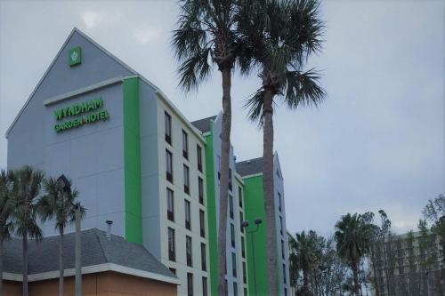 a building with a palm tree in front of it at Wyndham Garden Hotel - Jacksonville in Jacksonville