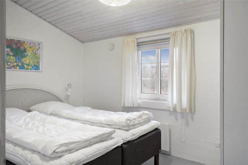 two beds in a room with a window at 20723-Ulfborg-Sortebaervej-1 in Ulfborg