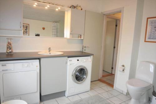 a bathroom with a washing machine and a sink at 20723-Ulfborg-Sortebaervej-1 in Ulfborg