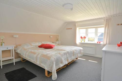 a bedroom with a bed and a window at 20202-Ulfborg-Husby-Klitvej-15 in Ulfborg