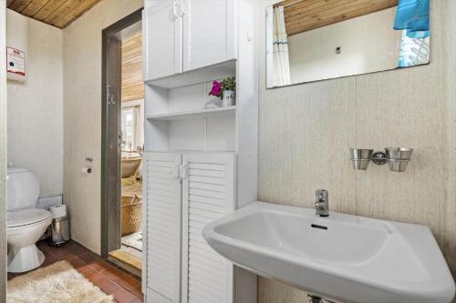 a bathroom with a sink and a toilet at 20202-Ulfborg-Husby-Klitvej-15 in Ulfborg