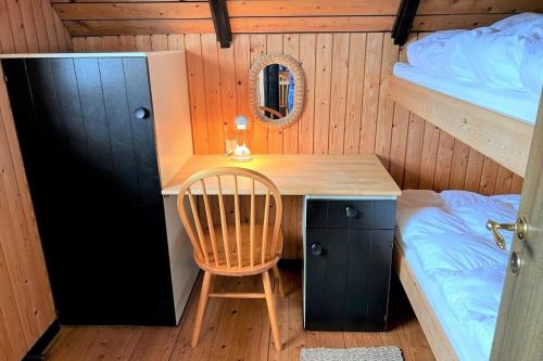 a desk in a room with a bed and a chair at 20039-Ulfborg-Sortebaervej-8 in Ulfborg