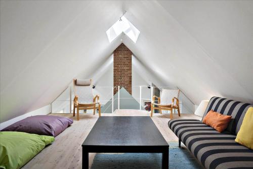 a room with a couch and a table in a attic at 20780-Ulfborg-Sundhuse-26 in Ulfborg