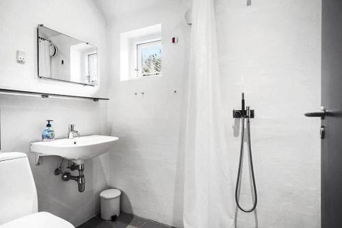 a white bathroom with a sink and a shower at 20780-Ulfborg-Sundhuse-26 in Ulfborg