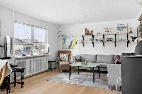 a living room with a couch and a table at 70268-Ulfborg-Vesterhavsgade-16 in Ulfborg