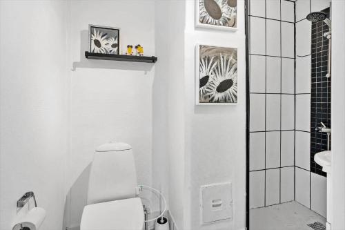a white bathroom with a toilet and a shower at 70268-Ulfborg-Vesterhavsgade-16 in Ulfborg