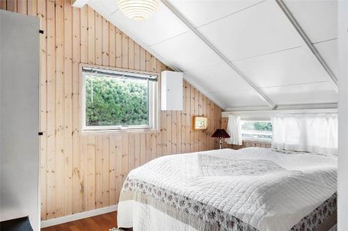 a bedroom with a white bed in a room with a window at 30071-Ulfborg-Klovervej-479 in Ulfborg