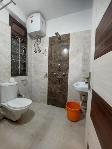 a bathroom with a toilet and a sink at Hotel white lion-Near Bhajra Taxi Stand in Gangtok